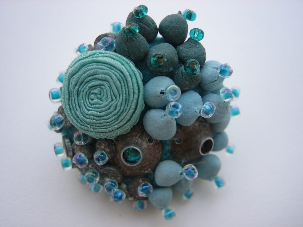 2004 ring with 'Aqua coral', porcelain, zinc, silk, swarovsky, glass beads, o3cm